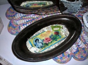 Cute silver tray adorned with lovelies! Sweet pink and blue crochet doily underneath made by my maternal grandma\'s hands